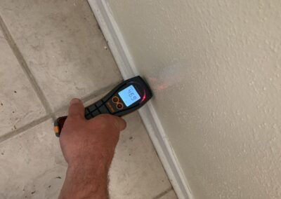Measuring wall with digital laser distance meter.