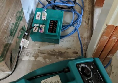 Industrial dehumidifier and air movers drying water damage.