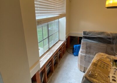 Empty room under renovation with packed furniture.