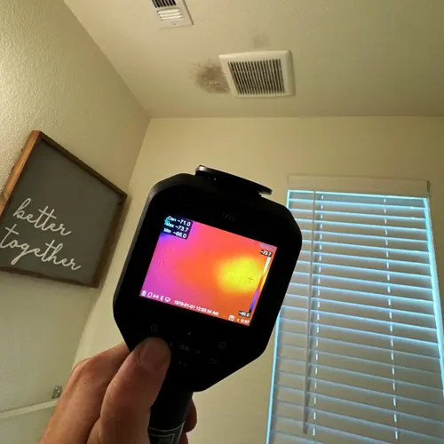 Boerne homeowner reviewing mold inspection report with restoration technician after visible growth found in attic